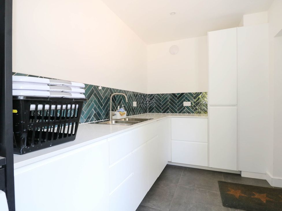 A kitchen with a sink and cabinets at Cree Cottage
