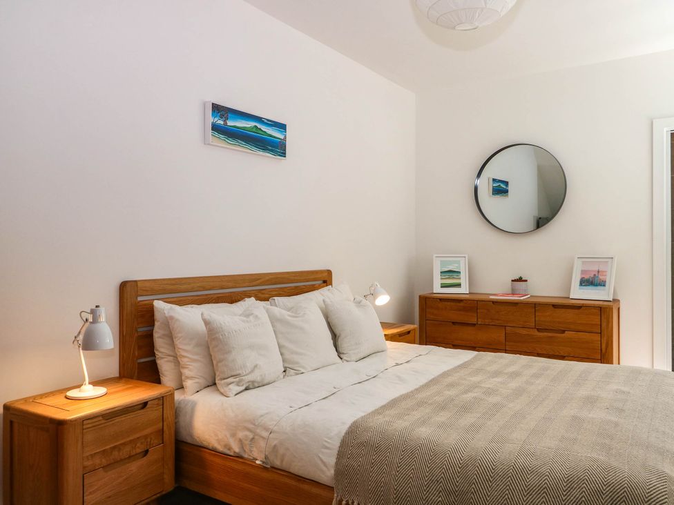 A bedroom with a bed and lamps at Cree Cottage