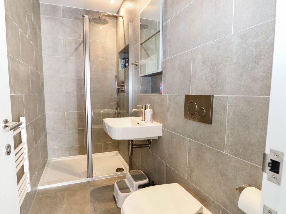 A bathroom with a shower, sink, and toilet at Cree Cottage in 