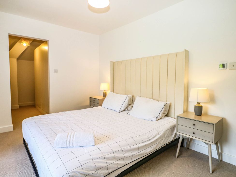 A bedroom with a bed and bedside tables at Cree Cottage