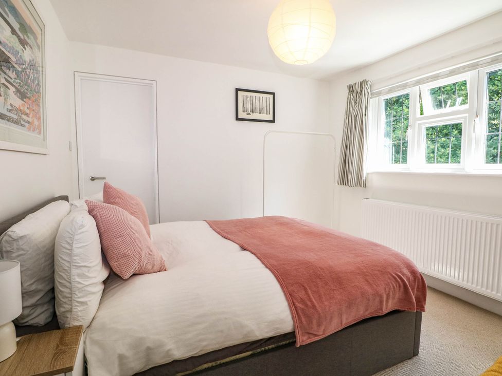 A bedroom with a bed and window at Cree Cottage