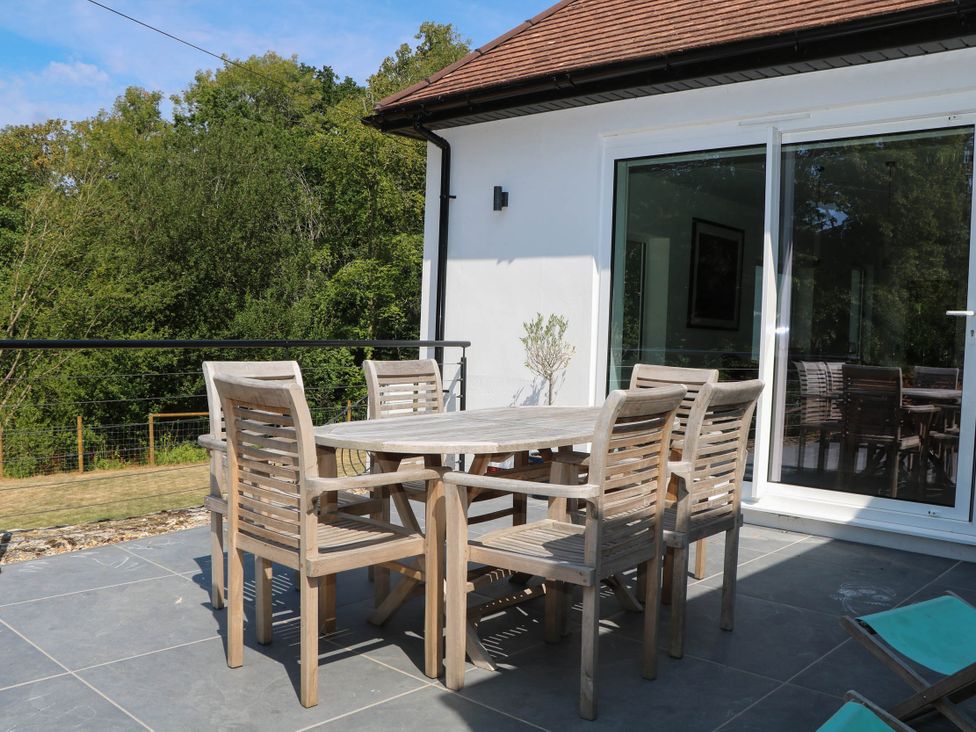 An outdoor dining area with a table and chairs at Cree Cottage