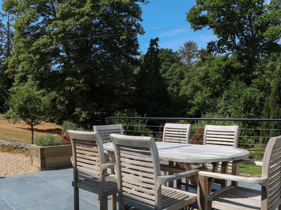 An outdoor seating area with a table and chairs at Cree Cottage