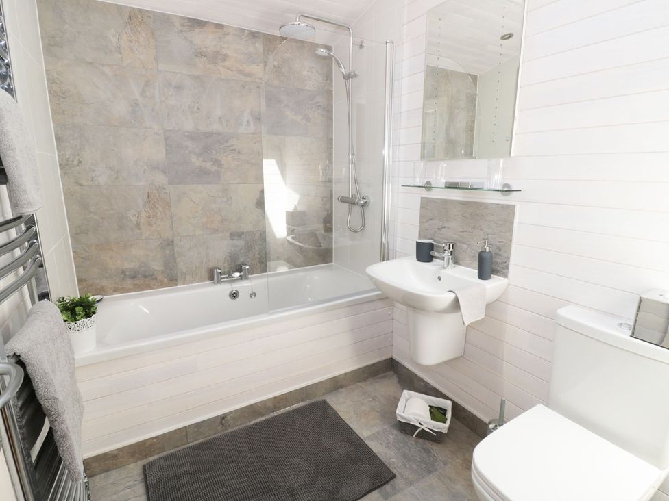 A bathroom with a bathtub and sink at Kingfisher in Ross-on-Wye