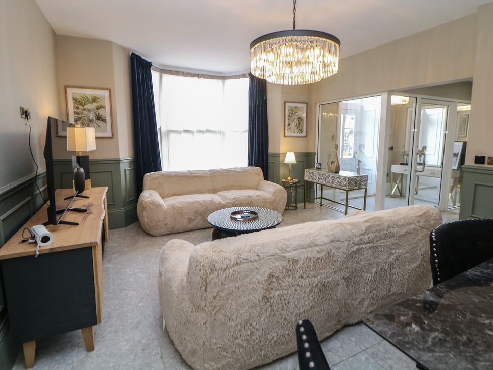 A living room with a sofa and coffee table at The Pavillon Suite in Buxton