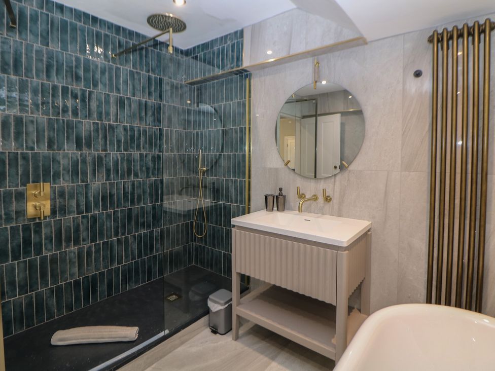 A bathroom with a shower and wash basin at The Pavillon Suite in Buxton