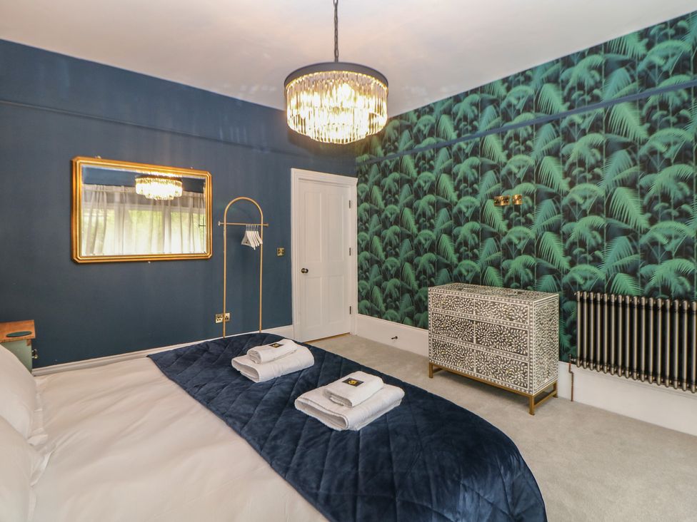 A bedroom with a bed and towels on it at The Pavillon Suite in Buxton