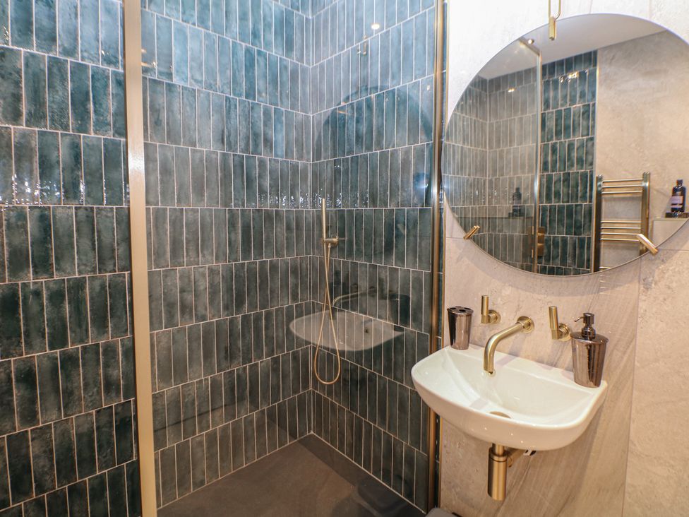 A bathroom with a shower and sink at The Pavillon Suite in Buxton