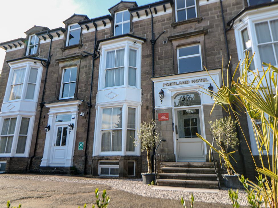 A hotel exterior with steps and planters at The Pavillon Suite in Buxton
