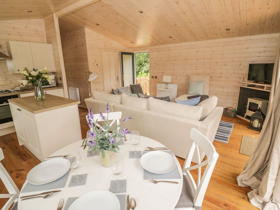 A living room with a sofa and dining area at Mallard in Ross-on-Wye