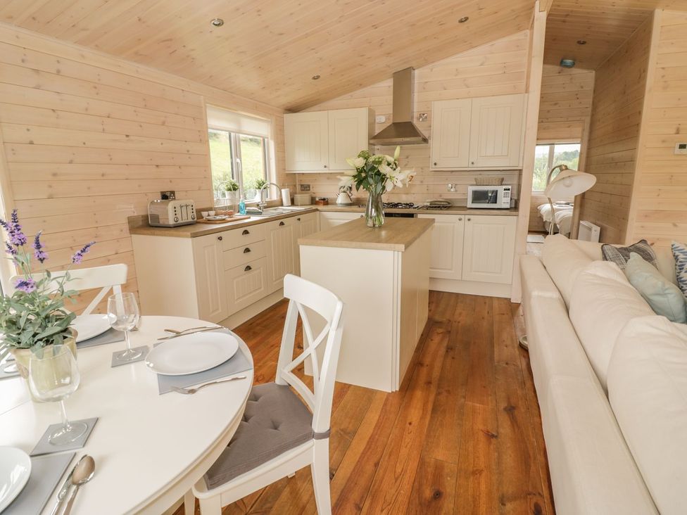 A kitchen with a dining area and sofa at Mallard in Ross-on-Wye