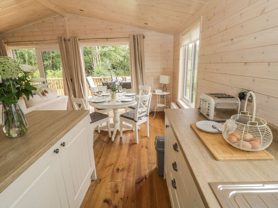 A kitchen with a table and chairs at Mallard in Ross-on-Wye