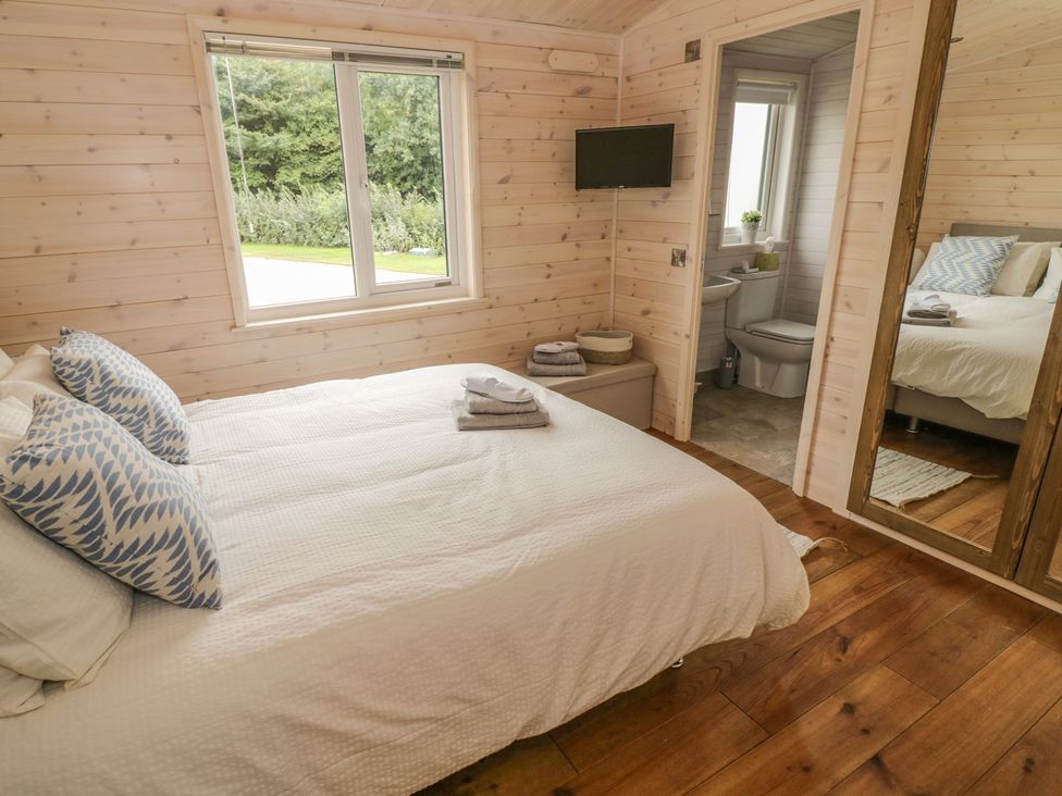 A bedroom with a bed and television at Mallard in Ross-on-Wye