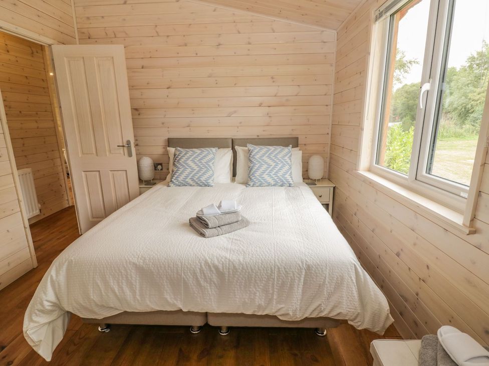 A bedroom with a bed and a window at Mallard in Ross-on-Wye