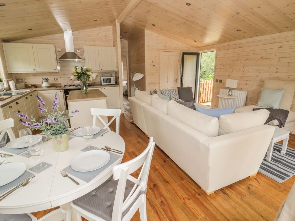 A living room with a kitchen area and dining table at Mallard in Ross-on-Wye