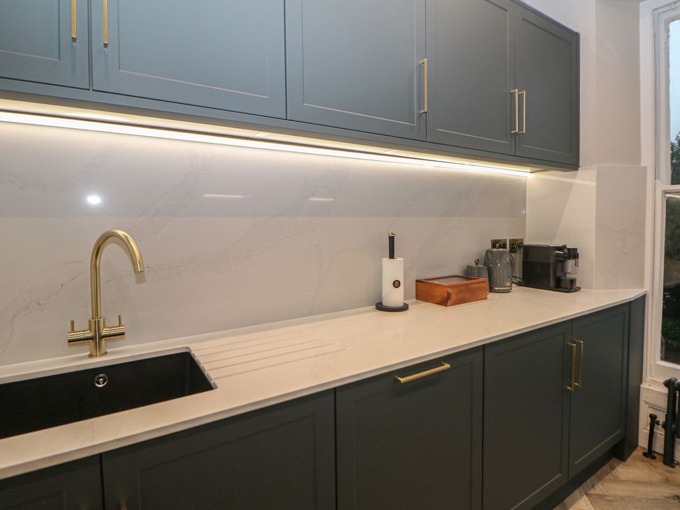 A kitchen with a sink and countertop in The Haddon Suite Buxton