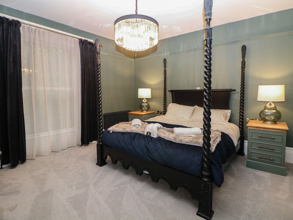 A bedroom with a four-poster bed and nightstands at The Haddon Suite in Buxton