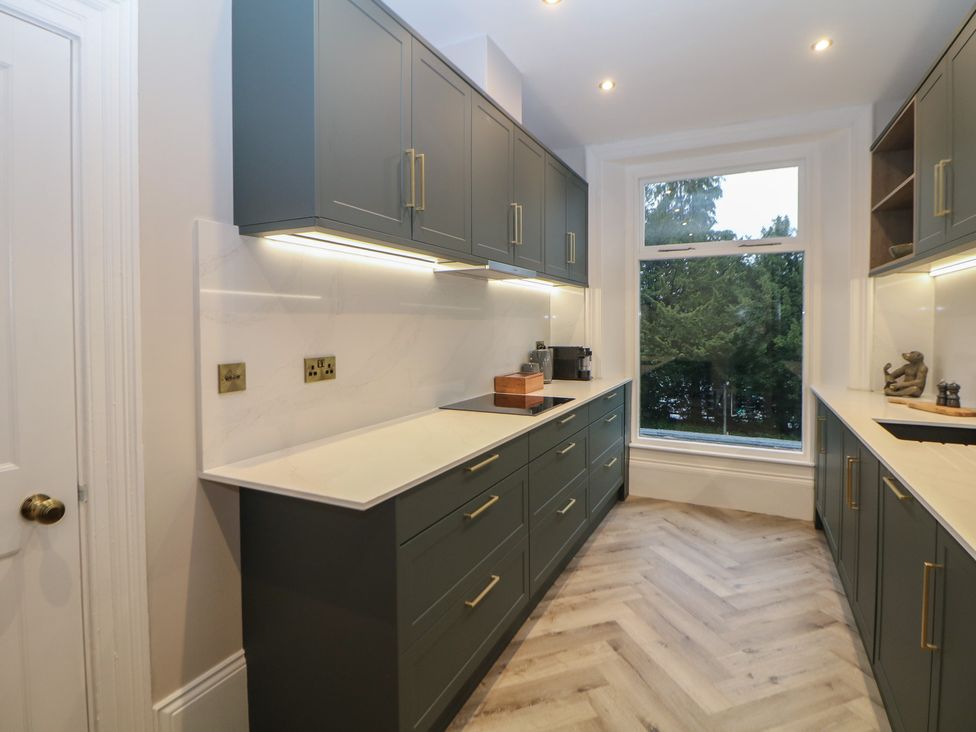 A kitchen with cabinets and countertops at The Chatsworth Suite in Buxton