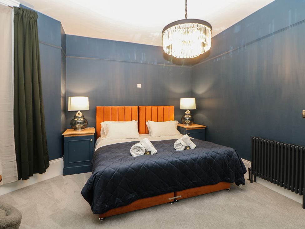 A bedroom with a bed and bedside tables at The Chatsworth Suite in Buxton