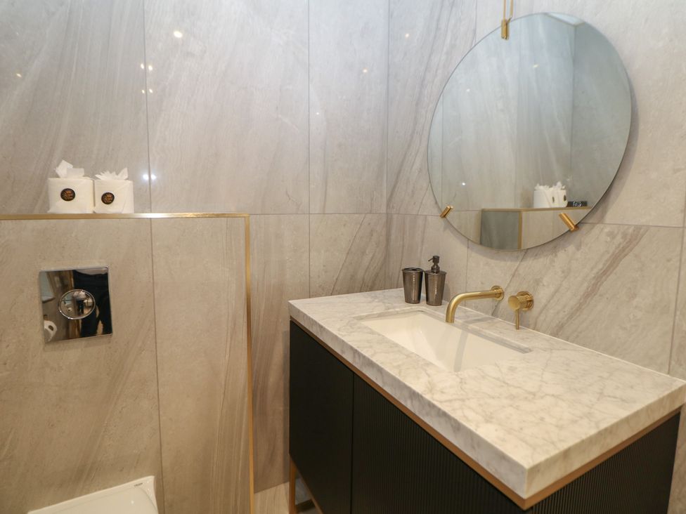A bathroom with sink and mirror at The Chatsworth Suite in Buxton