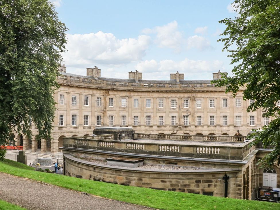 A building with windows and balustrade surrounded by grass at The Chatsworth Suite Buxton