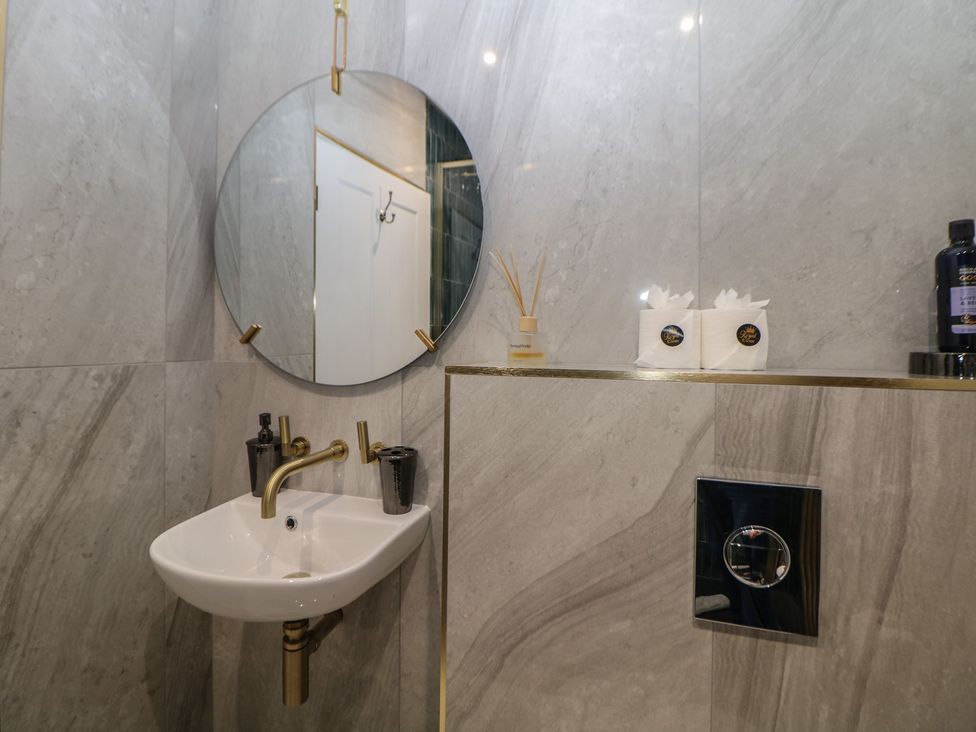 A bathroom featuring a sink and mirror at The Devonshire Suite in Buxton