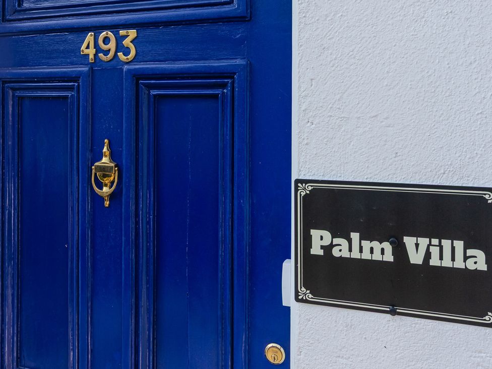A door with house number 493 and a nameplate at Palm Villa in Torquay