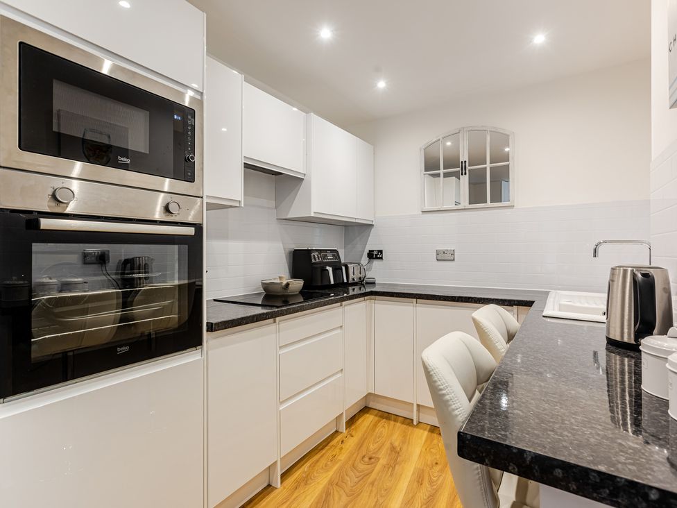 A kitchen with modern appliances at Palm Villa in Torquay