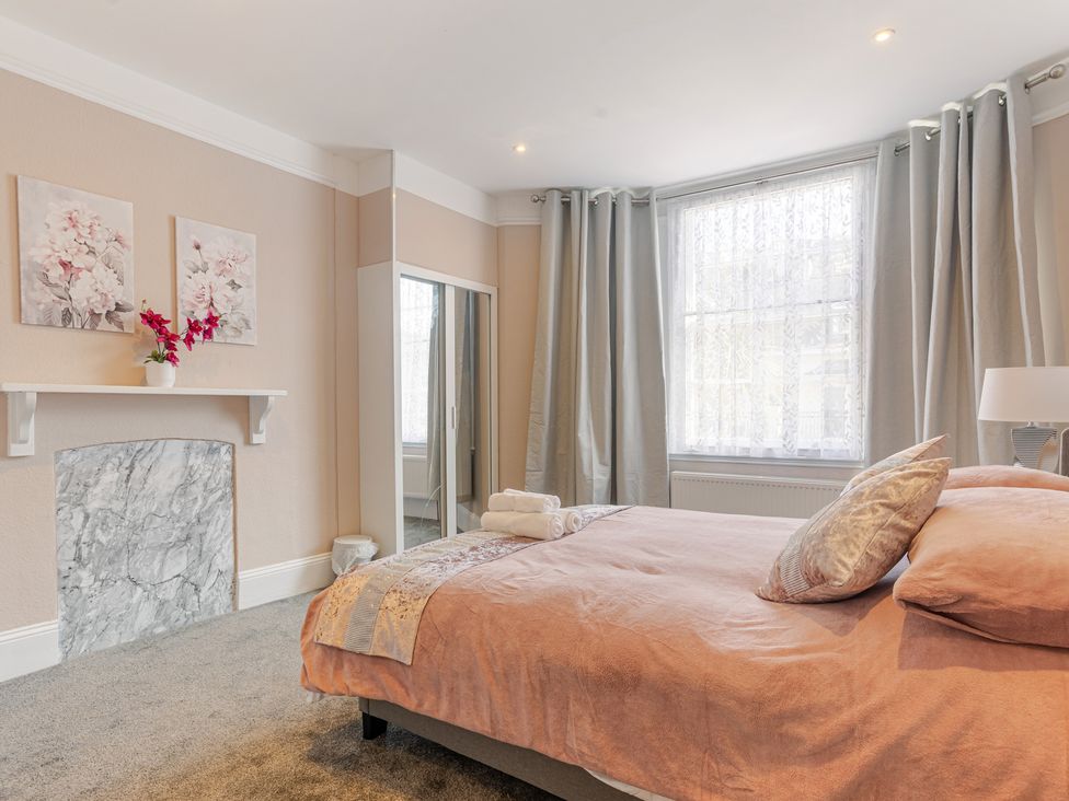 A bedroom with a bed and decorative art at Palm Villa in Torquay