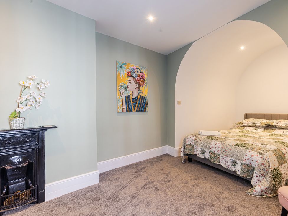 A bedroom with a bed and wall art at Palm Villa in Torquay