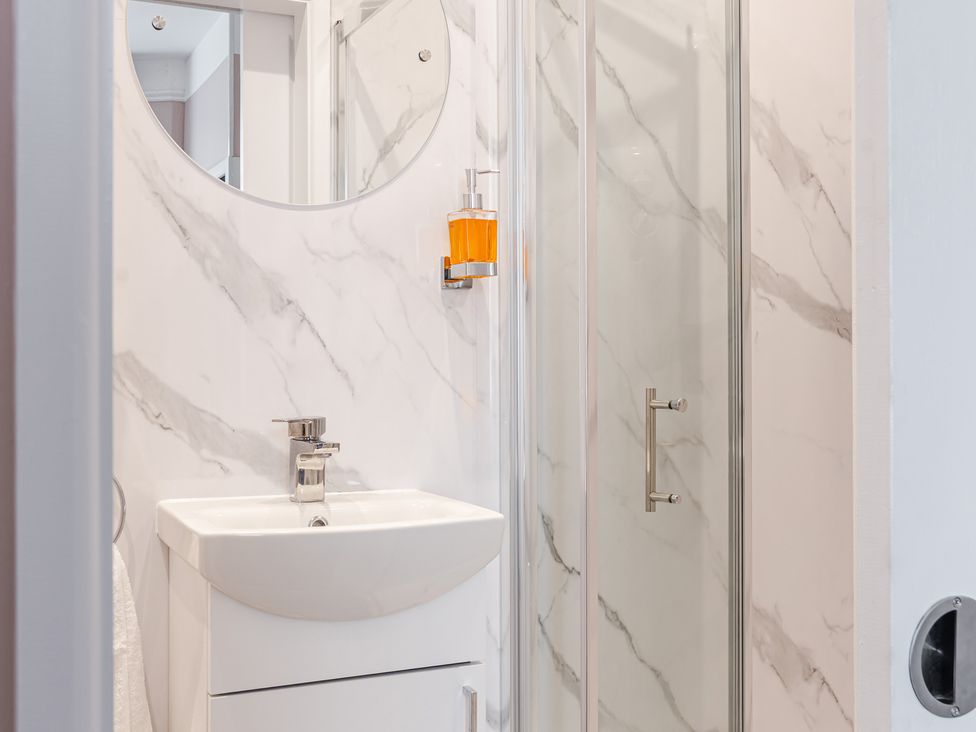 A bathroom featuring a sink and shower at Palm Villa in Torquay