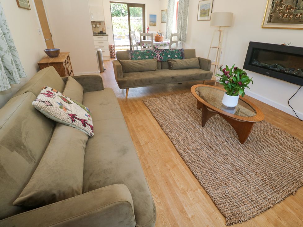 A living room with sofas and a coffee table at Yonde View in Camborne
