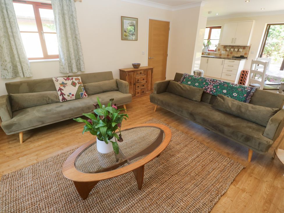 A living room with two sofas, a coffee table, and a plant at Yonde View Camborne