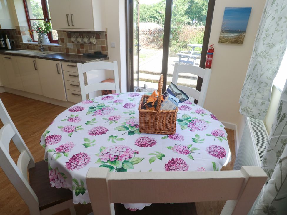 A kitchen with a dining table and chairs at Yonde View in Camborne