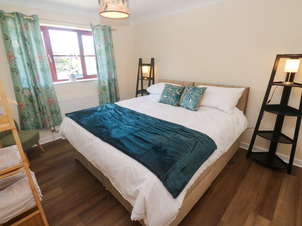 A bedroom with a bed and shelves at Yonde View, Camborne
