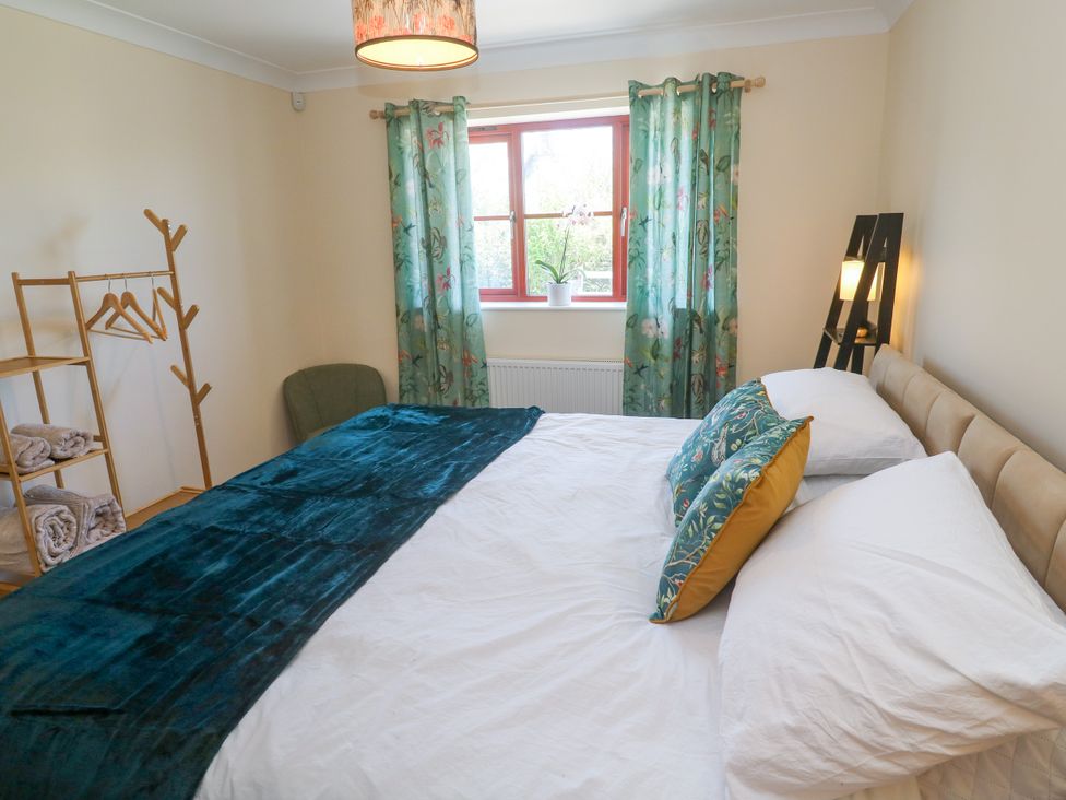 A bedroom with a bed and curtains at Yonde View Camborne
