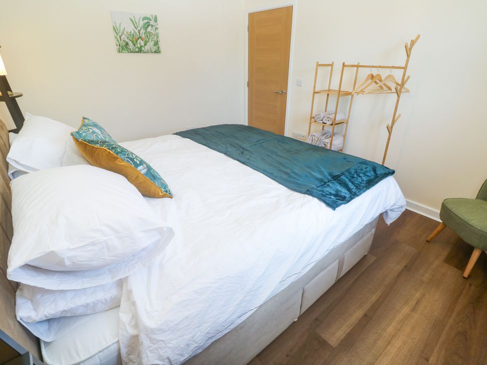 A bedroom with a bed and coat rack at Yonde View in Camborne