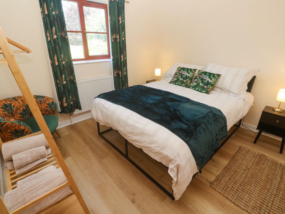 A bedroom with a bed and nightstand at Yonde View in Camborne