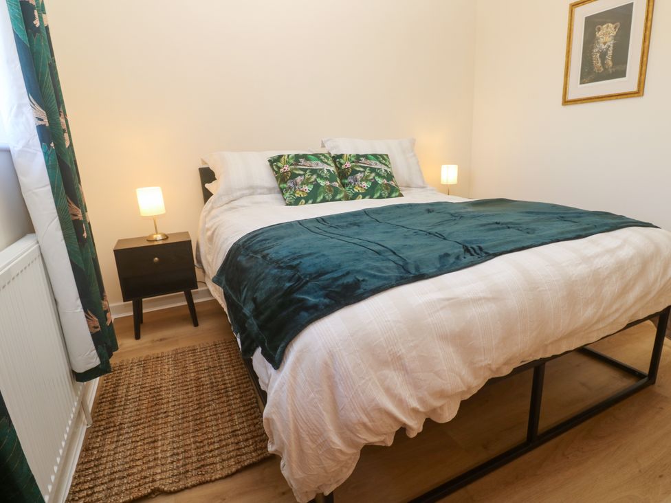 A bedroom with a bed and nightstand at Yonde View in Camborne