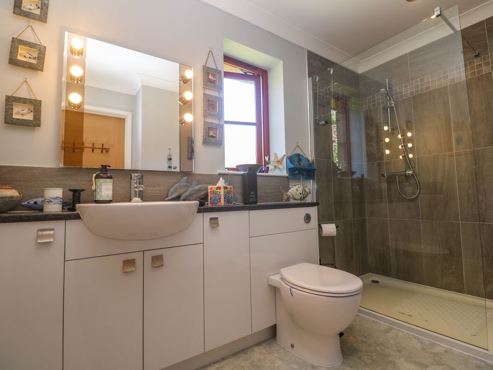 A bathroom with a sink, toilet, and shower at Yonde View in Camborne