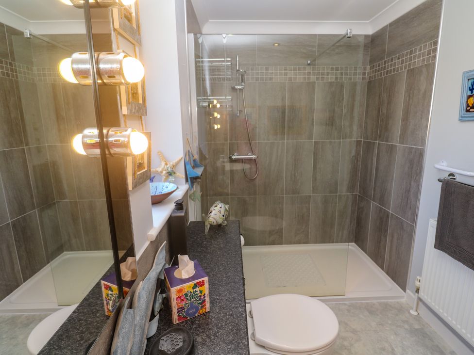 A bathroom with a shower and sink at Yonde View Camborne