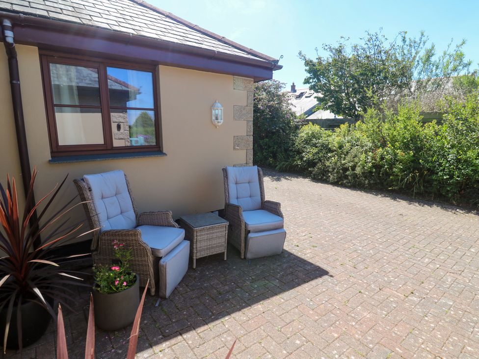 An outdoor area with two armchairs and a table at Yonde View in Camborne