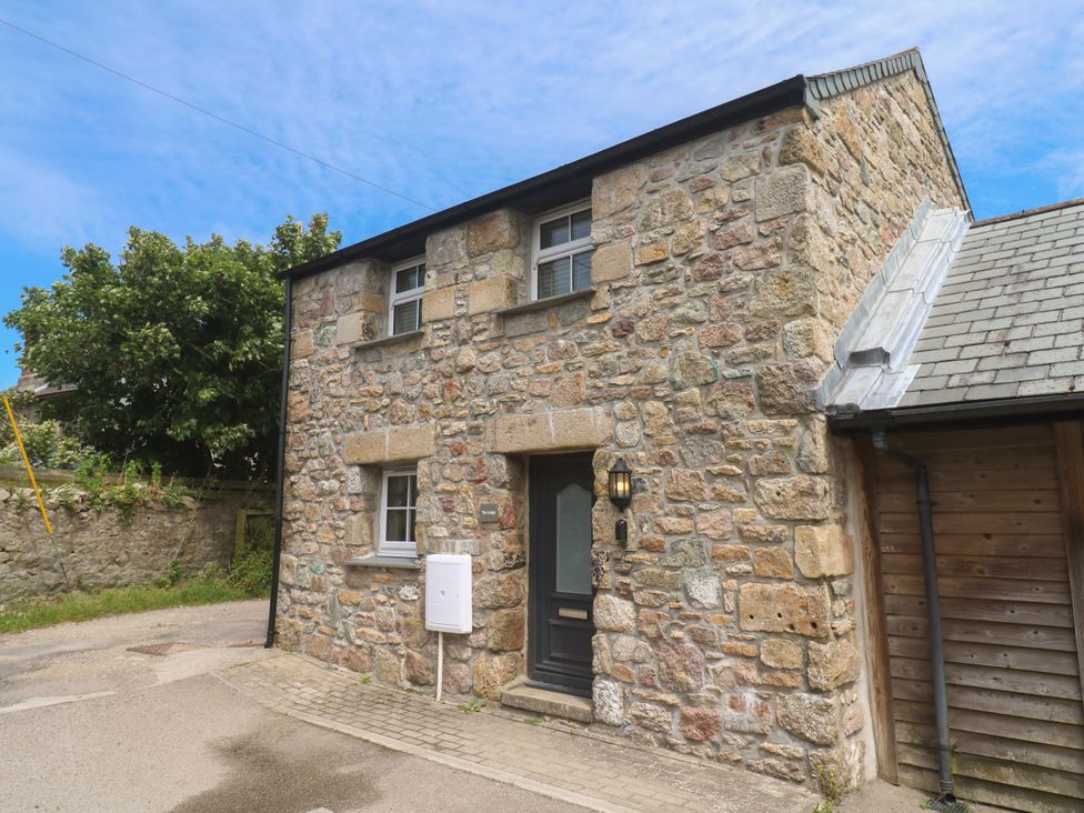 A stone building with a front door and windows at Gews Farm Lodge St Just
