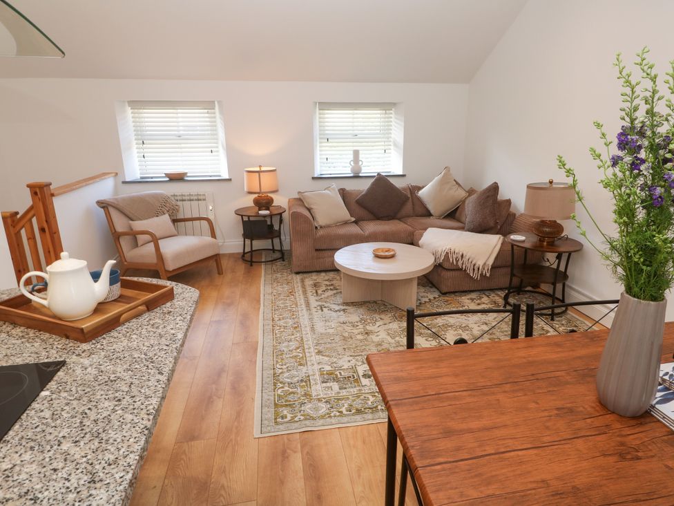 A living room with a sofa and coffee table at Gews Farm Lodge St Just