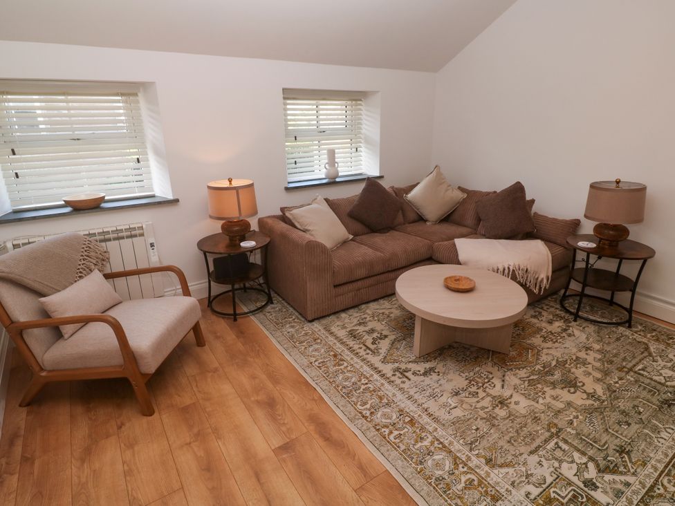 A living room with a sofa and coffee table at Gews Farm Lodge in St Just