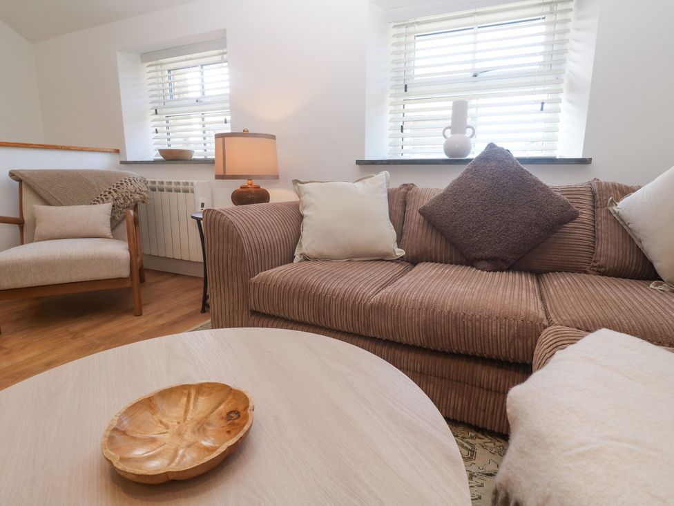 A living room with a sofa and armchair at Gews Farm Lodge St Just