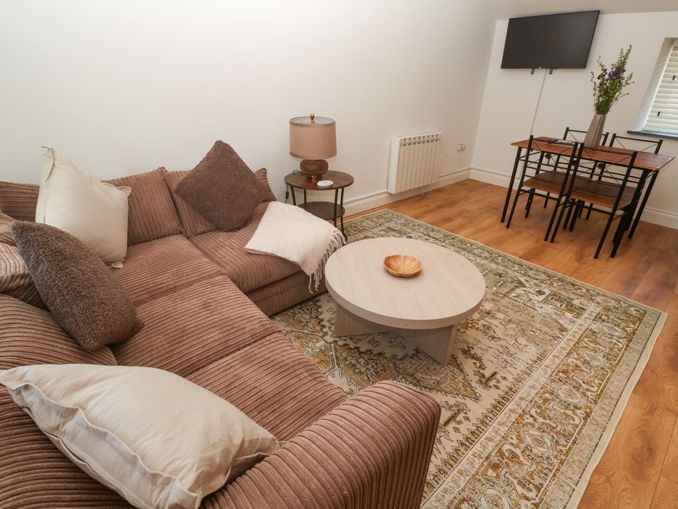 A living room with a sofa and coffee table at Gews Farm Lodge in St Just