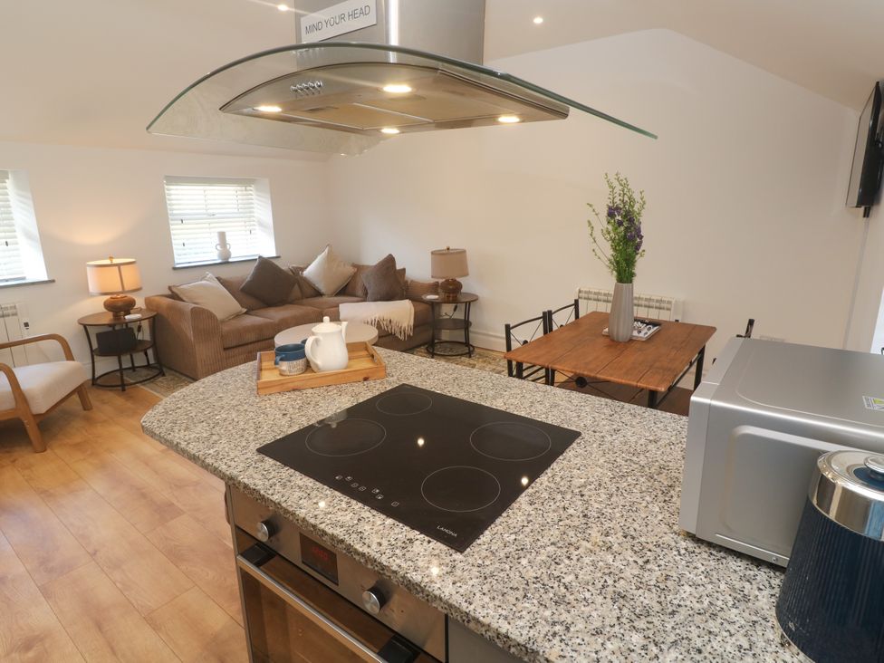 A kitchen with a countertop and seating area at Gews Farm Lodge St Just