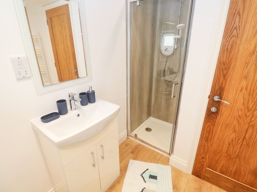 A bathroom with sink and shower at Gews Farm Lodge St Just