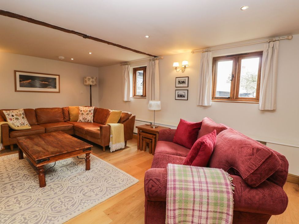 A living room with sofa and coffee table at The Old Barn in Hereford